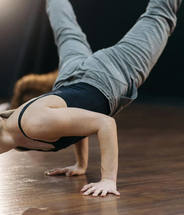 Athlete in a powerful yoga warrior pose, showing strength and focus.
